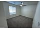 Cozy bedroom with neutral tones, carpet, and ceiling fan, creating a comfortable space at 8006 W Gibson Ln, Phoenix, AZ 85043