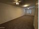 Large bedroom with neutral walls, ceiling fans, plush carpet, and window with blinds at 8006 W Gibson Ln, Phoenix, AZ 85043
