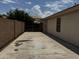 Side yard with long, extra wide driveway with secured gate between block wall and house at 8006 W Gibson Ln, Phoenix, AZ 85043