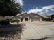 Traditional home with a two-car garage, simple desert landscaping, and a neutral color scheme at 8006 W Gibson Ln, Phoenix, AZ 85043