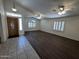Bright living room features wood laminate flooring, vaulted ceiling, and ample natural light from the windows at 8006 W Gibson Ln, Phoenix, AZ 85043