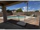Back yard view of the fenced in pool area with palm trees and privacy at 8006 W Gibson Ln, Phoenix, AZ 85043