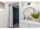 Bathroom featuring updated vanity with marble countertop, modern mirror, and blue-tiled shower at 849 N Revere -- # E, Mesa, AZ 85201