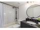 Beautiful bathroom featuring tiled shower-over-tub and dark vanity with round mirror at 849 N Revere -- # E, Mesa, AZ 85201
