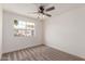 Bright bedroom with neutral carpet, white walls, and a window offering outdoor views at 849 N Revere -- # E, Mesa, AZ 85201