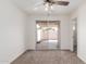Bedroom with a sliding glass door leading to the backyard, neutral colors, and carpet at 849 N Revere -- # E, Mesa, AZ 85201