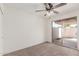 Spacious bedroom featuring a ceiling fan and sliding glass door to the patio at 849 N Revere -- # E, Mesa, AZ 85201