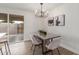 Elegant dining room featuring a modern chandelier, a dining table, and stylish decor at 849 N Revere -- # E, Mesa, AZ 85201