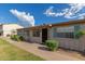Quaint single-story house featuring blue shutters, a small garden, and an accessible front entrance at 849 N Revere -- # E, Mesa, AZ 85201