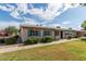Inviting single-story property showcasing tidy landscaping, blue shutters, and a paved walkway at 849 N Revere -- # E, Mesa, AZ 85201