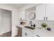 Close-up of modern kitchen details including stainless steel sink, white countertops and cabinets at 849 N Revere -- # E, Mesa, AZ 85201