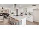 Open kitchen with island seating and views into living room; modern, neutral design at 849 N Revere -- # E, Mesa, AZ 85201
