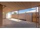 Covered patio with concrete flooring and secure wrought iron gate at 849 N Revere -- # E, Mesa, AZ 85201