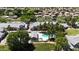 Aerial view of a planned community with mature trees, manicured lawns, and community pool and spa at 860 N Mcqueen Rd # 1058, Chandler, AZ 85225