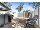 Private backyard with brick patio, white fences, and lounge chairs. Perfect for relaxing and entertaining at 860 N Mcqueen Rd # 1058, Chandler, AZ 85225