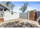 Secluded backyard featuring a brick patio area, surrounded by white fencing for privacy and relaxation at 860 N Mcqueen Rd # 1058, Chandler, AZ 85225