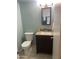 Cozy half-bathroom with vanity, toilet, neutral paint, and decorative yellow watering can at 860 N Mcqueen Rd # 1058, Chandler, AZ 85225