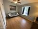 Spare bedroom featuring wood laminate flooring, ceiling fan, and a large window at 860 N Mcqueen Rd # 1058, Chandler, AZ 85225