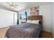 Comfortable bedroom featuring a wood-framed bed and a large window overlooking the outdoors at 860 N Mcqueen Rd # 1058, Chandler, AZ 85225