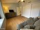 Bedroom featuring wood laminate flooring, a ceiling fan, and a couch at 860 N Mcqueen Rd # 1058, Chandler, AZ 85225