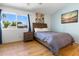 Cozy bedroom featuring a wood-framed bed, side table, and a large window overlooking the outdoors at 860 N Mcqueen Rd # 1058, Chandler, AZ 85225