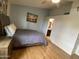 Bedroom featuring wood laminate flooring, ensuite bathroom, and serene blue walls at 860 N Mcqueen Rd # 1058, Chandler, AZ 85225