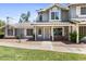 Charming two-story home featuring a well-maintained lawn, tiled roof, and inviting front porch at 860 N Mcqueen Rd # 1058, Chandler, AZ 85225