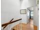 Upstairs hallway with wood floors and stairs leading to bedrooms with plenty of natural light at 860 N Mcqueen Rd # 1058, Chandler, AZ 85225