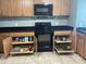 Efficient kitchen design with wooden cabinets, pull-out shelves and modern appliances at 860 N Mcqueen Rd # 1058, Chandler, AZ 85225