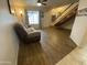 View of a cozy living room with wood floors, a staircase, and a comfortable seating area at 860 N Mcqueen Rd # 1058, Chandler, AZ 85225