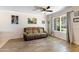 Comfortable living room with a large window, ceiling fan, and neutral-toned walls and wood floors at 860 N Mcqueen Rd # 1058, Chandler, AZ 85225