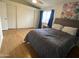 Main bedroom featuring wood laminate flooring, a ceiling fan, and a walk-in closet at 860 N Mcqueen Rd # 1058, Chandler, AZ 85225