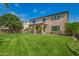 Expansive backyard featuring a well-maintained lawn and covered patio, ideal for outdoor gatherings at 881 E Boston St, Gilbert, AZ 85295