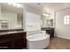 Bathroom boasts a large soaking tub, double sinks, and dark wood cabinets at 881 E Boston St, Gilbert, AZ 85295