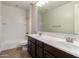 A bathroom with double sink vanity, a large mirror, tile flooring, and a shower-tub combination at 881 E Boston St, Gilbert, AZ 85295
