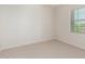 A bright bedroom with neutral carpet, ceiling fan, and window with blinds at 881 E Boston St, Gilbert, AZ 85295