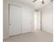 Bright bedroom featuring a closet with sliding doors, neutral carpet, and ceiling fan at 881 E Boston St, Gilbert, AZ 85295