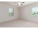 A bright and airy bedroom featuring neutral carpet, ceiling fan, and window with blinds at 881 E Boston St, Gilbert, AZ 85295