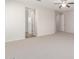 Carpeted bedroom with neutral walls, ceiling fan, and multiple doorways for versatile use at 881 E Boston St, Gilbert, AZ 85295