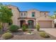 Inviting two-story home with a charming entry, desert landscaping, and a two car garage at 881 E Boston St, Gilbert, AZ 85295