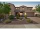 Charming two-story home with arched entryway, desert landscaping, and attached garage at 881 E Boston St, Gilbert, AZ 85295