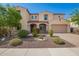 Charming two-story home with arched entryway, desert landscaping, and attached garage at 881 E Boston St, Gilbert, AZ 85295