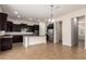 Spacious kitchen features a center island, stainless steel refrigerator and dark wood cabinets at 881 E Boston St, Gilbert, AZ 85295