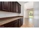 Kitchen features granite countertops, dark wood cabinets, and an open view to the backyard at 881 E Boston St, Gilbert, AZ 85295