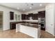 Bright kitchen with dark wood cabinets, stainless steel appliances, and a granite-topped island at 881 E Boston St, Gilbert, AZ 85295