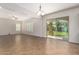 Spacious living room with tile flooring, plantation shutters, and sliding doors to the backyard at 881 E Boston St, Gilbert, AZ 85295