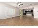 Bright and airy living room with tile flooring, shutters, and an open floor plan to the kitchen at 881 E Boston St, Gilbert, AZ 85295