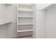A bright, clean walk-in closet with multiple shelves and ample hanging space at 881 E Boston St, Gilbert, AZ 85295