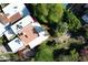 Expansive aerial view of a home with red-tiled roofs, mature trees, and backyard pool at 9430 S 47Th Pl, Phoenix, AZ 85044