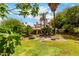 Lush backyard featuring mature trees, green grass, patio area with outdoor furniture, and an inviting atmosphere at 9430 S 47Th Pl, Phoenix, AZ 85044